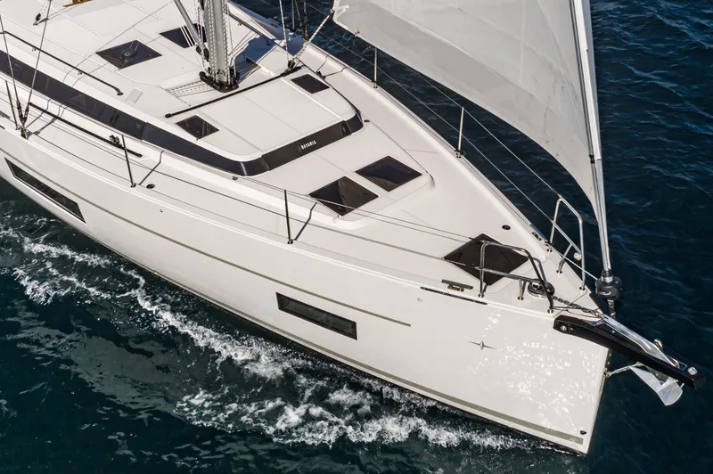 Slide: The Image of 2024 Bavaria C45 sailing yacht cruising on open water. - 19