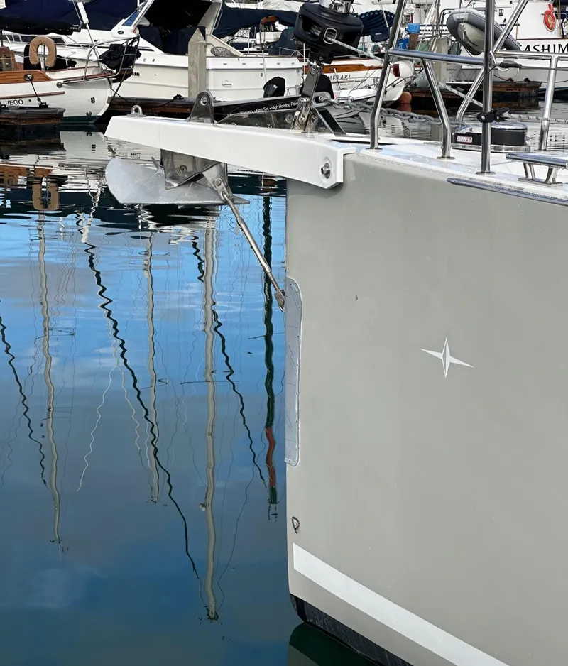 Slide: The Image of 2024 Bavaria C45 yacht bow in marina, reflecting on calm water. - 3