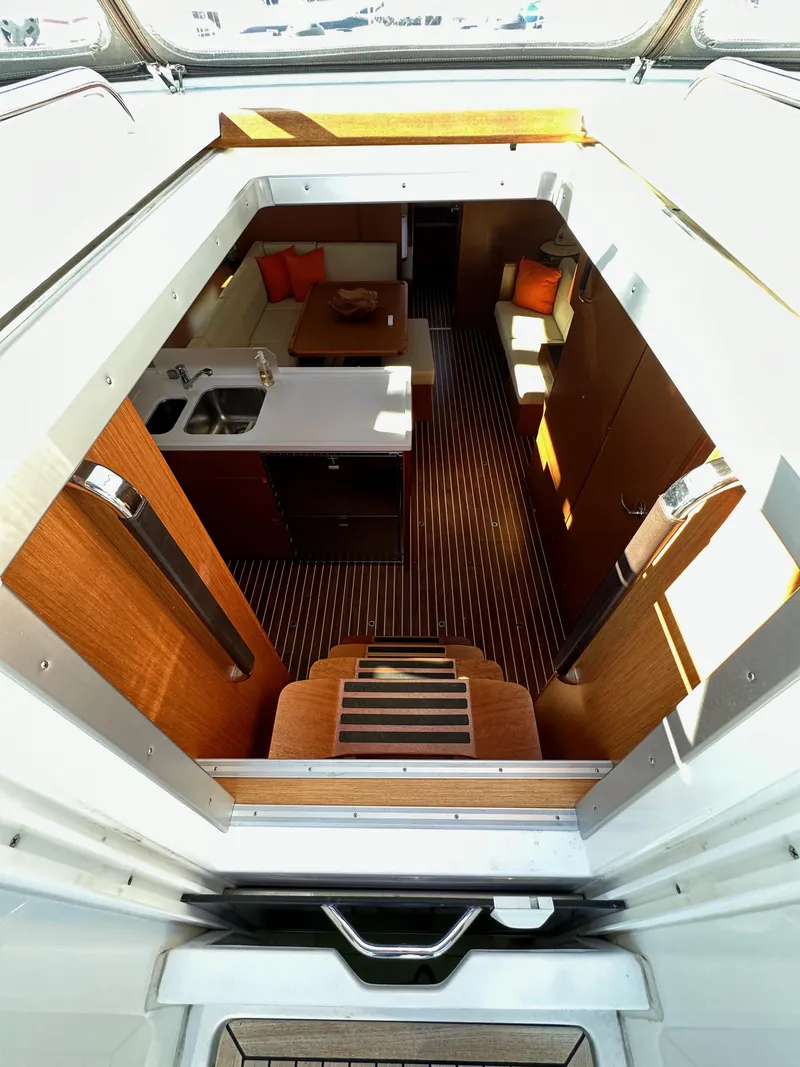 Slide: The Image of 2024 Bavaria C45 yacht interior with modern kitchen and seating area. - 33