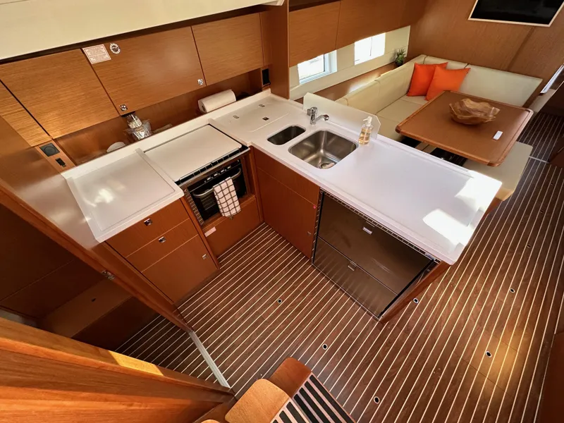 Slide: The Image of Luxurious 2024 Bavaria C45 yacht interior with modern kitchen and dining area. - 35
