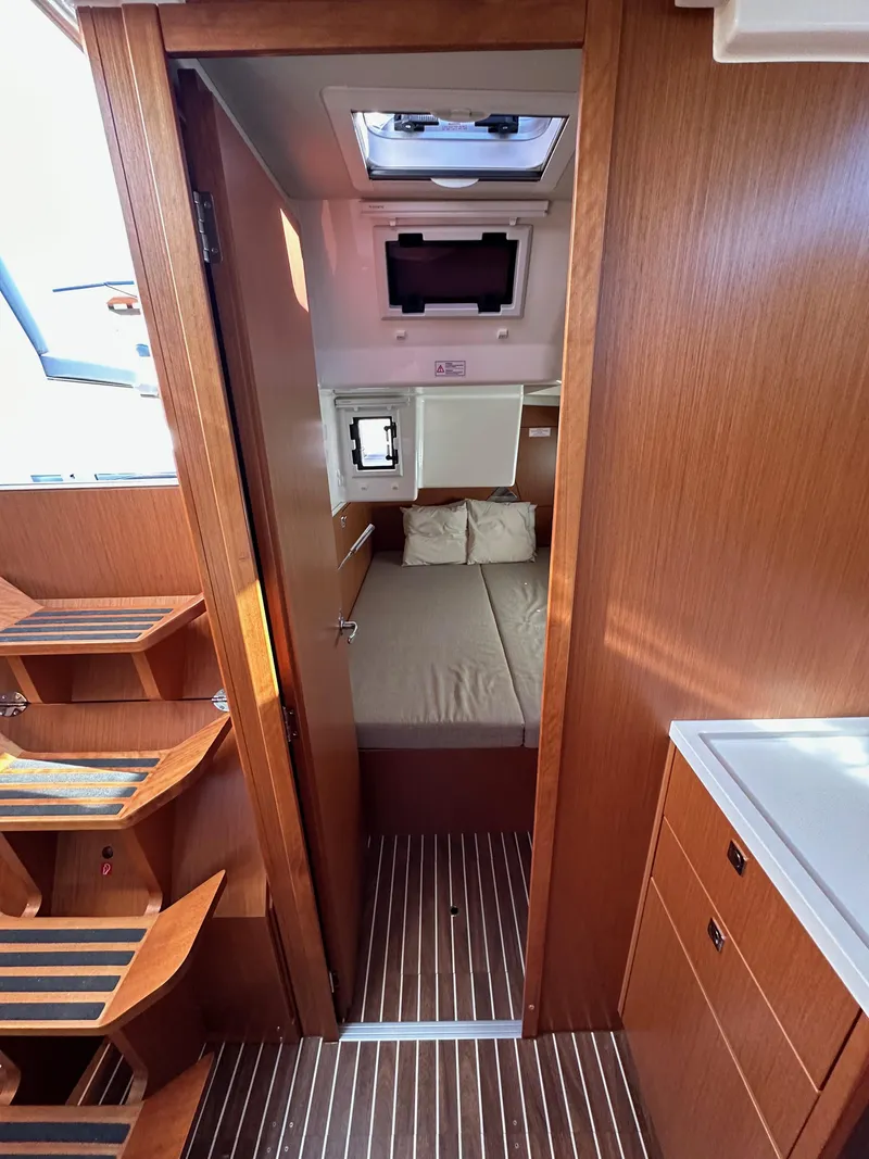 Slide: The Image of 2024 Bavaria C45 yacht interior with wooden finish and cozy cabin. - 40