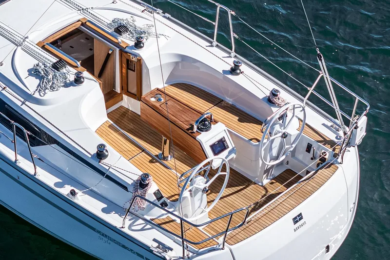 Slide: The Image of 2024 Bavaria Cruiser 34 sailboat with dual steering wheels and teak deck. - 15