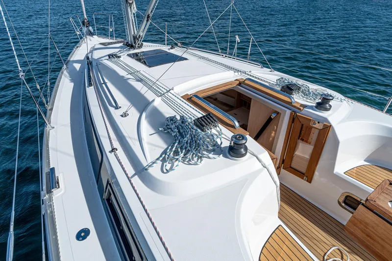 Slide: The Image of 2024 Bavaria Cruiser 34 sailboat deck with open cabin, sailing on blue water. - 20