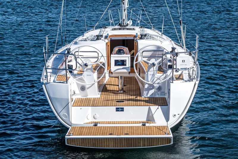 Slide: The Image of 2024 Bavaria Cruiser 34 yacht on water, featuring dual steering wheels and teak deck. - 22