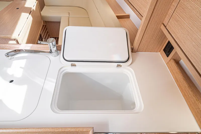 Slide: The Image of Modern kitchen sink and storage on 2024 Bavaria Cruiser 34 yacht. - 34