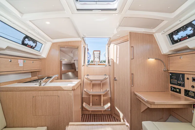 Slide: The Image of 2024 Bavaria Cruiser 34 interior with modern wood finish and compact kitchen. - 36