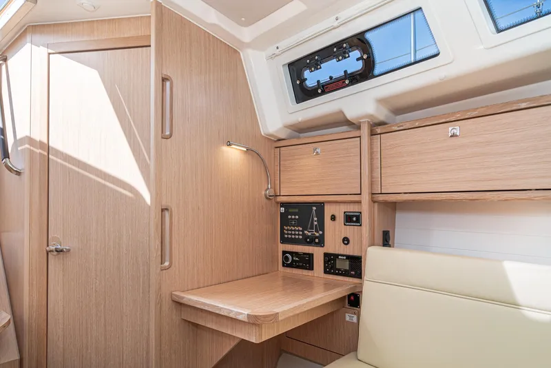 Slide: The Image of Interior of 2024 Bavaria Cruiser 34 yacht with modern wood finish and navigation panel. - 37