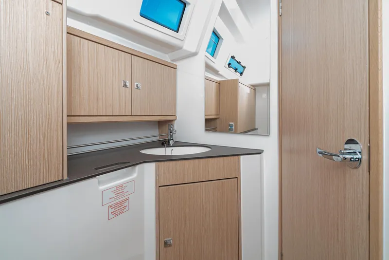 Slide: The Image of Modern bathroom interior of 2024 Bavaria Cruiser 34 yacht with wood cabinetry and sleek design. - 41