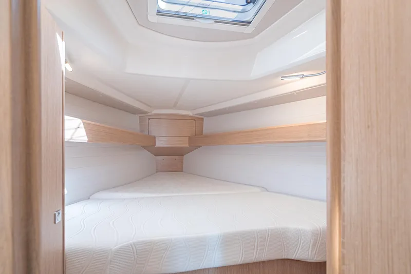 Slide: The Image of 2024 Bavaria Cruiser 34 interior cabin with skylight and cozy bedding. - 43
