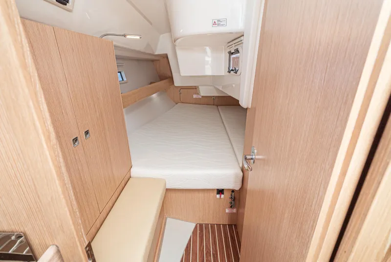 Slide: The Image of 2024 Bavaria Cruiser 34 cabin interior with wooden finish and comfortable bedding. - 44