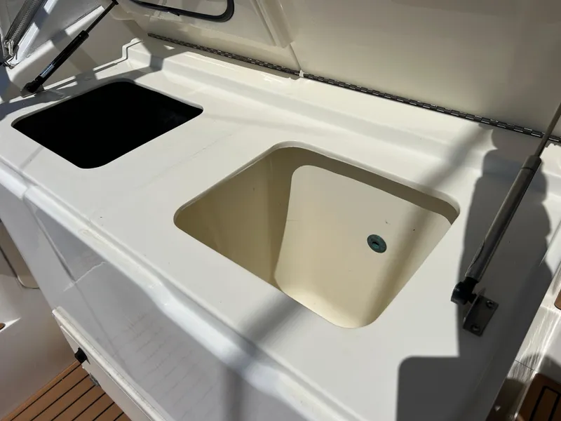 Slide: The Image of Albemarle 410 Express Fisherman 2002 boat sink and storage compartments. - 10