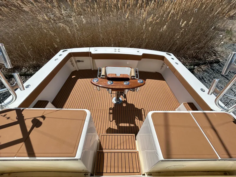 Slide: The Image of 2002 Albemarle 410 Express Fisherman boat deck with seating and fishing equipment. - 13