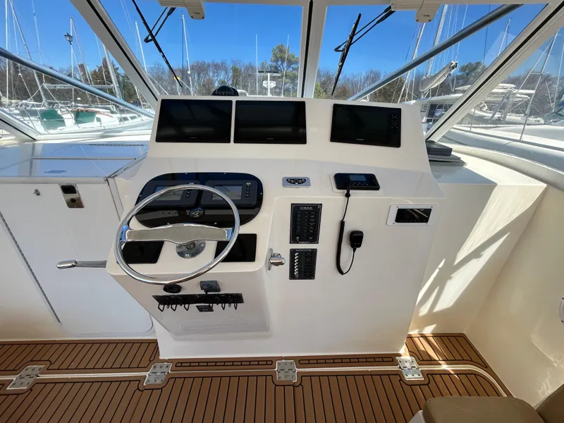Slide: The Image of 2002 Albemarle 410 Express Fisherman helm with modern controls and navigation screens. - 15
