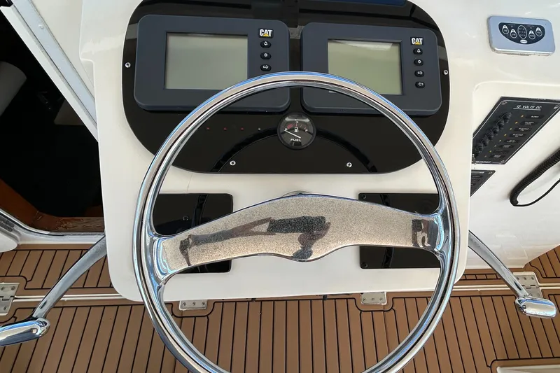 Slide: The Image of Steering wheel and controls of 2002 Albemarle 410 Express Fisherman boat. - 16