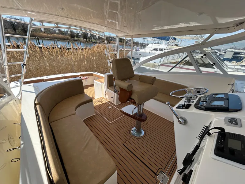 Slide: The Image of 2002 Albemarle 410 Express Fisherman boat interior with seating and helm station. - 17