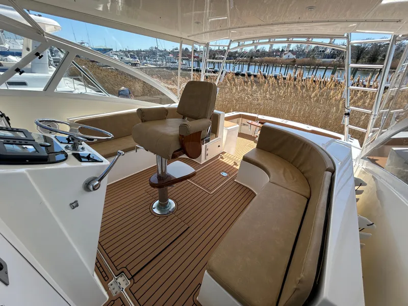 Slide: The Image of 2002 Albemarle 410 Express Fisherman boat interior with helm and seating area. - 18