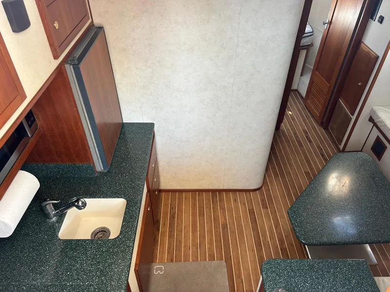 Slide: The Image of Interior of 2002 Albemarle 410 Express Fisherman with kitchenette and wood flooring. - 19