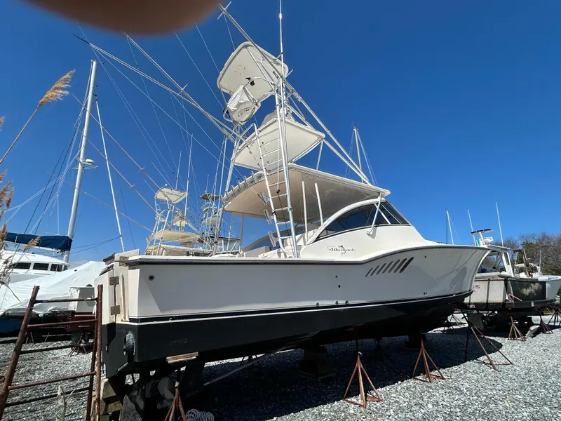 Slide: The Image of 2002 Albemarle 410 Express Fisherman boat on stands, clear blue sky background. - 2