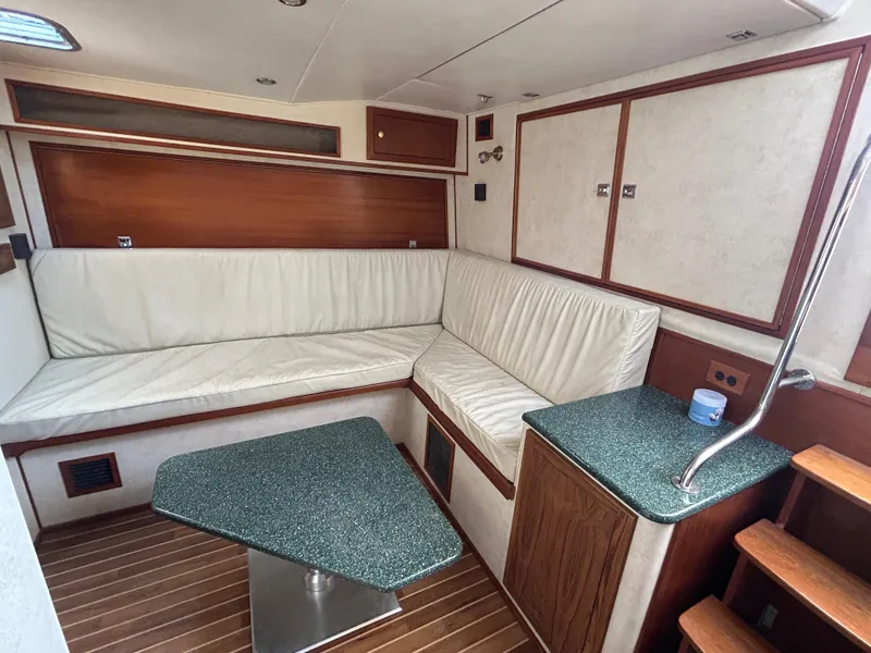Slide: The Image of Interior of 2002 Albemarle 410 Express Fisherman with white seating and wooden accents. - 22