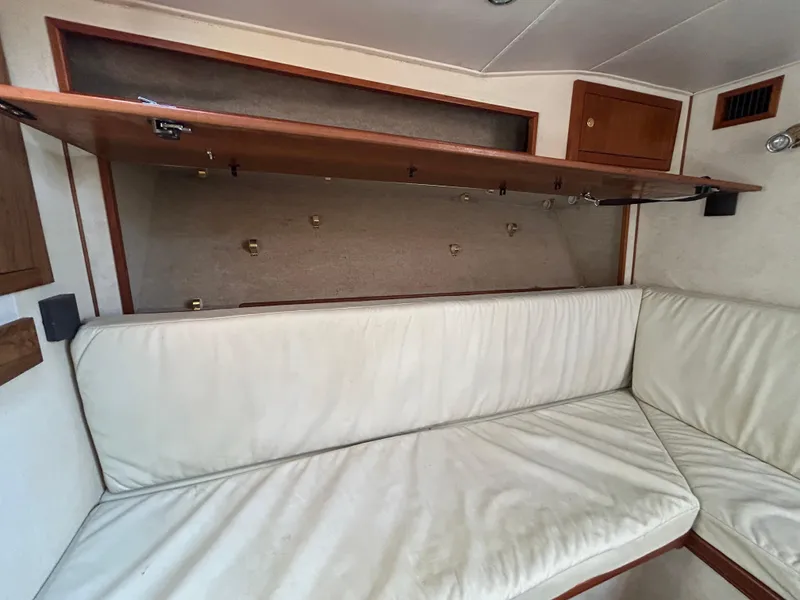 Slide: The Image of Interior of 2002 Albemarle 410 Express Fisherman with white cushioned seating and storage. - 24