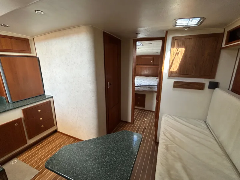Slide: The Image of Interior of 2002 Albemarle 410 Express Fisherman, featuring wood cabinetry and seating area. - 25
