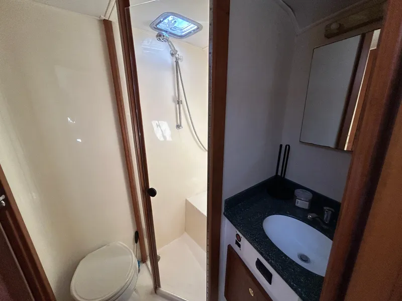 Slide: The Image of 2002 Albemarle 410 Express Fisherman bathroom with shower, toilet, and sink. - 27