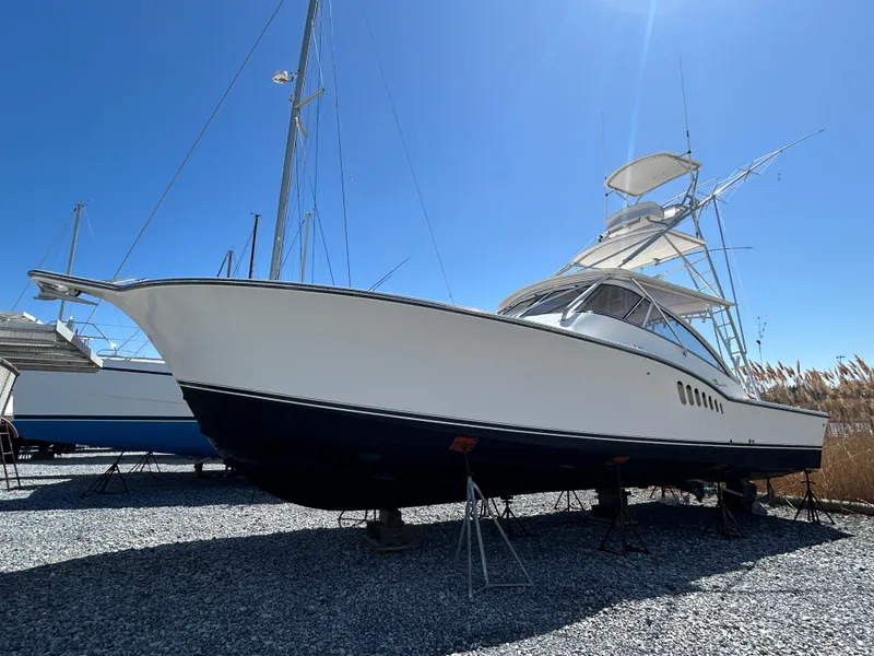 Slide: The Image of 2002 Albemarle 410 Express Fisherman boat on stands, clear sky background. - 3