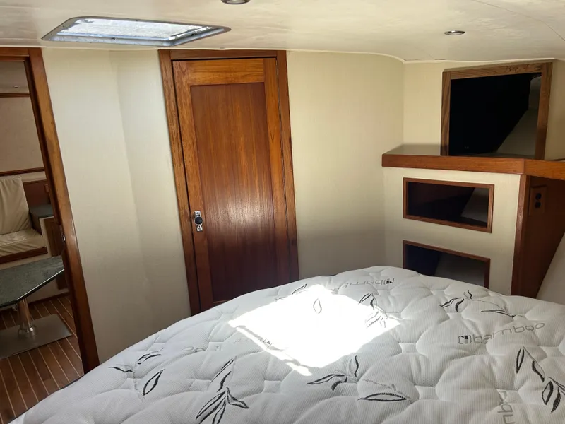 Slide: The Image of Interior cabin of 2002 Albemarle 410 Express Fisherman with bed and wooden accents. - 31