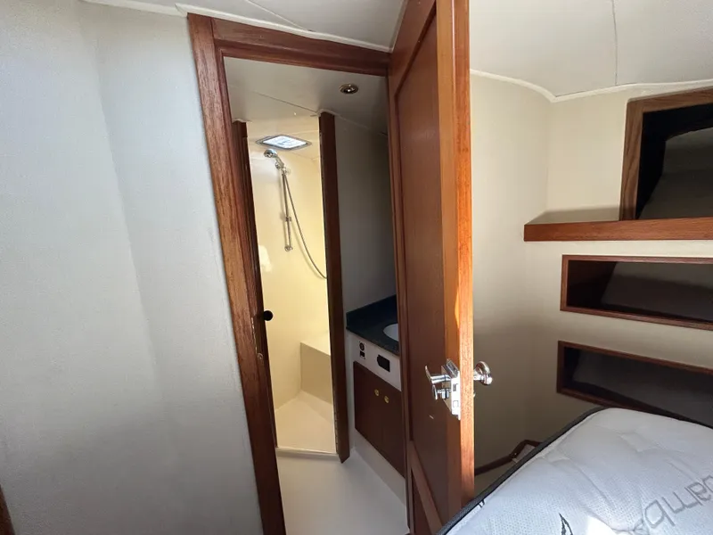 Slide: The Image of 2002 Albemarle 410 Express Fisherman cabin interior with open door to bathroom. - 32