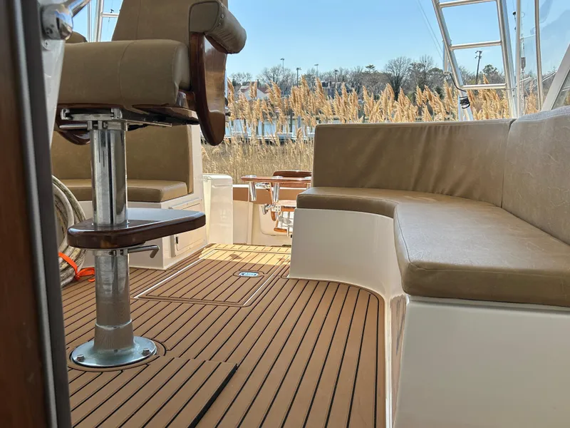 Slide: The Image of 2002 Albemarle 410 Express Fisherman boat interior with cushioned seating and wooden flooring. - 33