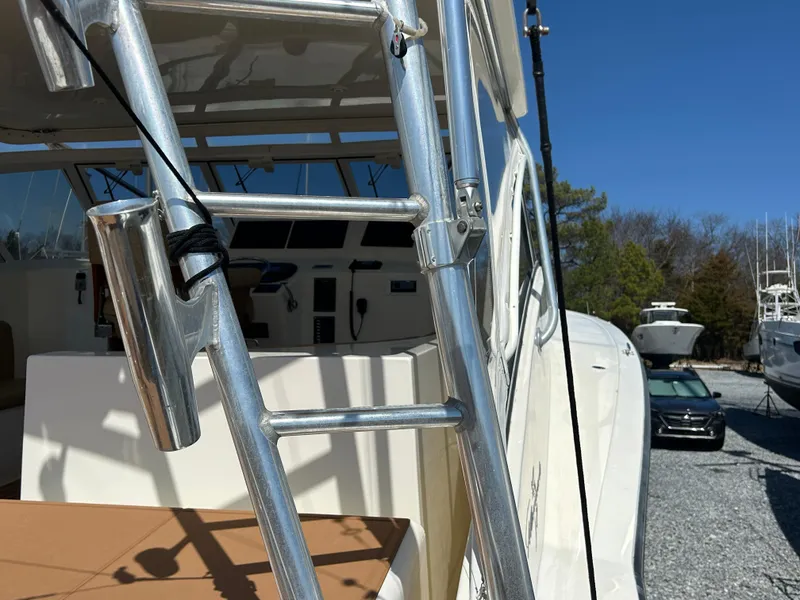 Slide: The Image of Albemarle 410 Express Fisherman 2002 boat ladder and cockpit, parked outdoors. - 34