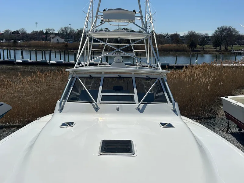 Slide: The Image of 2002 Albemarle 410 Express Fisherman boat docked near a serene waterfront. - 37