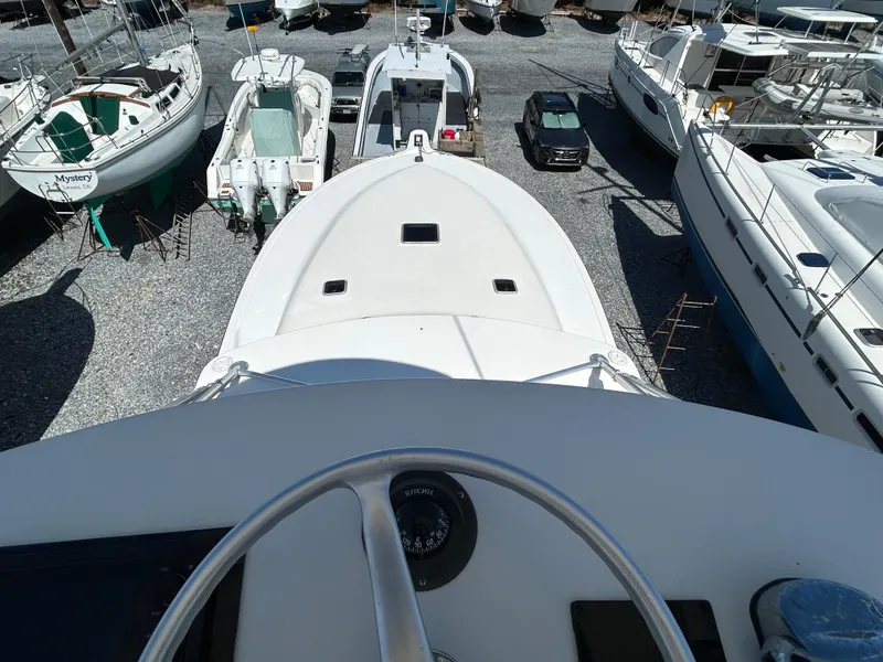 Slide: The Image of 2002 Albemarle 410 Express Fisherman boat in storage yard, surrounded by other vessels. - 42