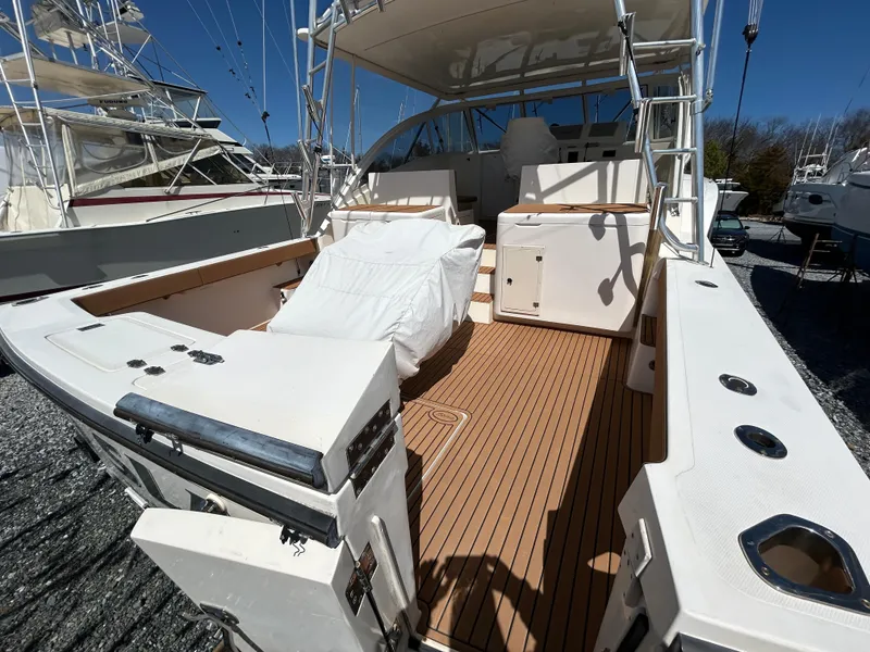 Slide: The Image of 2002 Albemarle 410 Express Fisherman boat with spacious deck and seating area. - 6