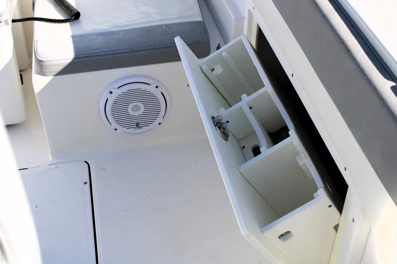 Slide: The Image of Open storage compartment in 2020 Release 240 RX boat interior. - 19