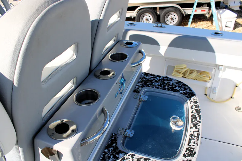Slide: The Image of 2020 Release 240 RX boat interior with cup holders and storage compartment. - 23