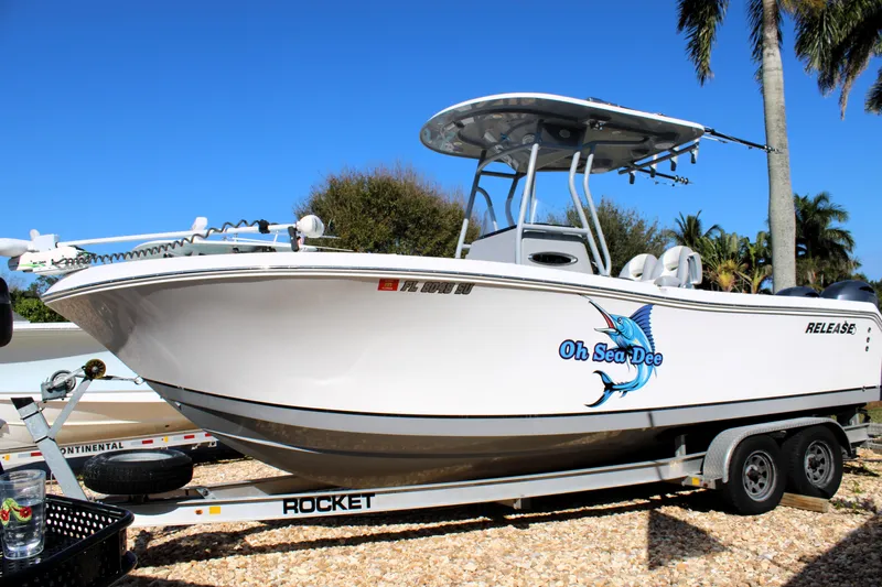 Slide: The Image of 2020 Release 240 RX boat on trailer, featuring "Oh Sea Dee" graphic, palm trees in background. - 33