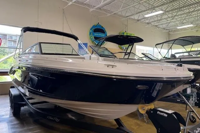 The Image of 2025 Sea Ray SPX 230 boat displayed indoors, featuring sleek design and modern features. - 0