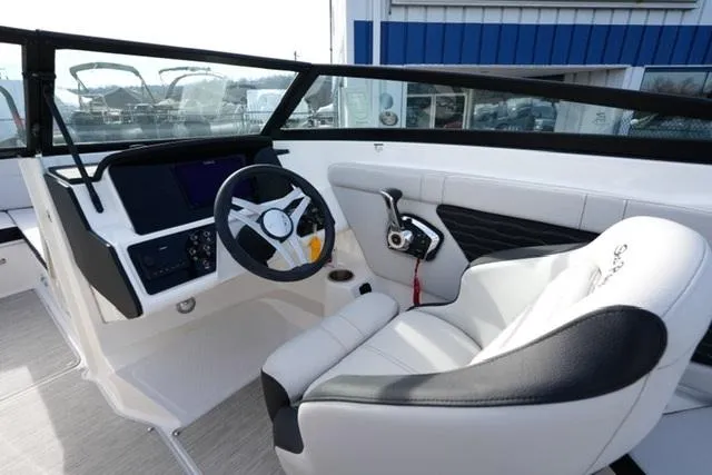 Slide: The Image of 2025 Sea Ray SPX 230 boat interior with modern steering and comfortable seating. - 10