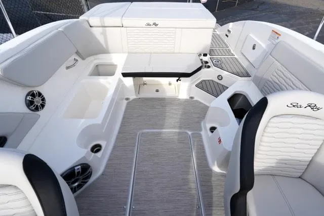 Slide: The Image of 2025 Sea Ray SPX 230 boat interior with white seating and modern design. - 13