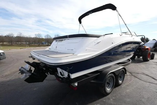Slide: The Image of 2025 Sea Ray SPX 230 boat on trailer, rear view, parked outdoors. - 4