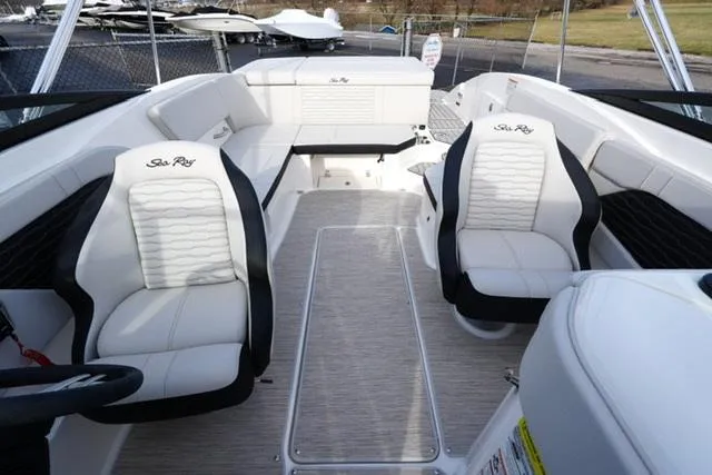 Slide: The Image of 2025 Sea Ray SPX 230 boat interior with white seating and modern design. - 6