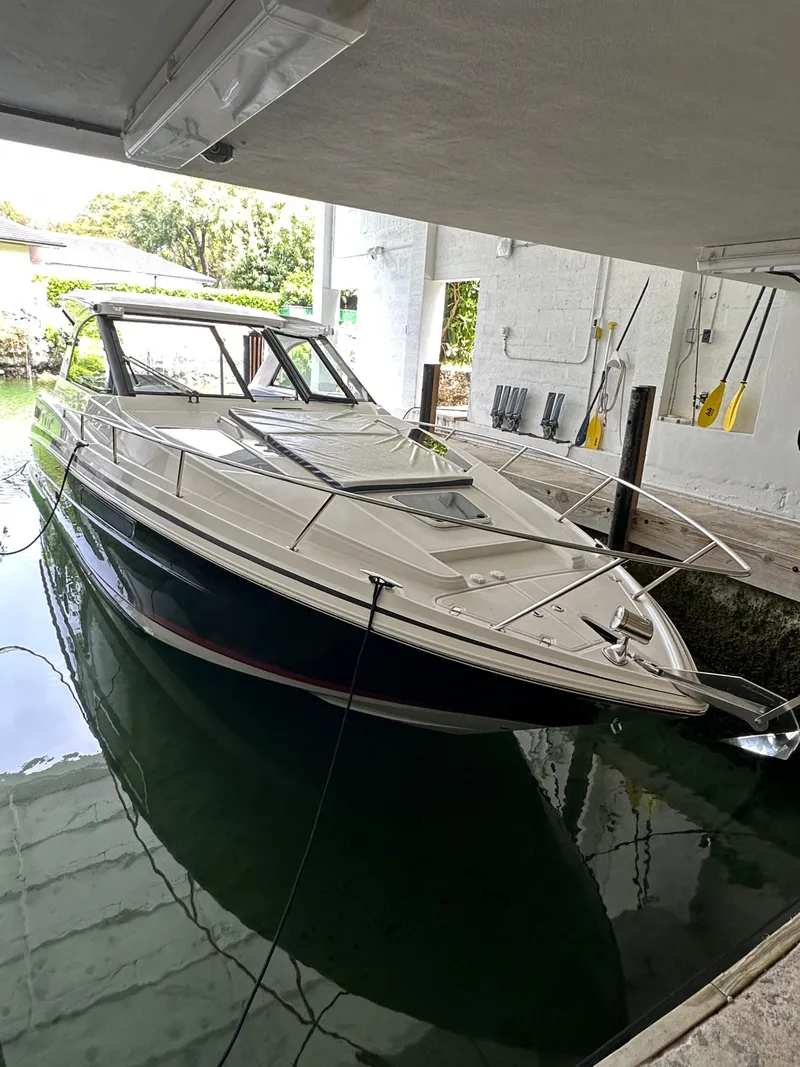 The Image of 2014 Regal 35 Sport Coupe docked in covered marina. - 0