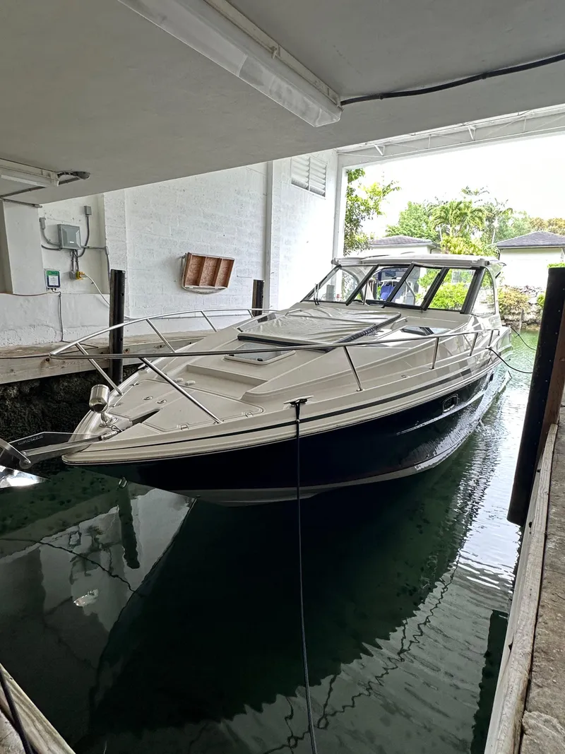 Slide: The Image of 2014 Regal 35 Sport Coupe docked in a covered marina. - 1