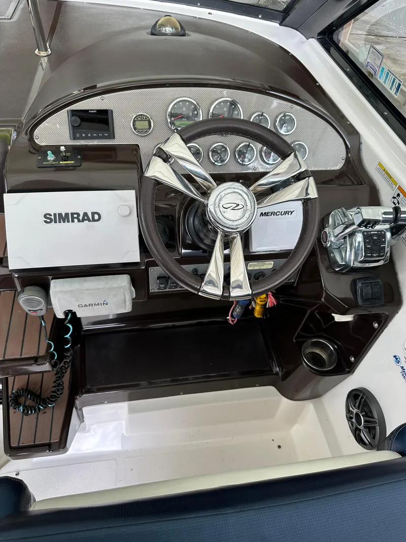 Slide: The Image of 2014 Regal 35 Sport Coupe dashboard with Simrad and Mercury controls. - 12