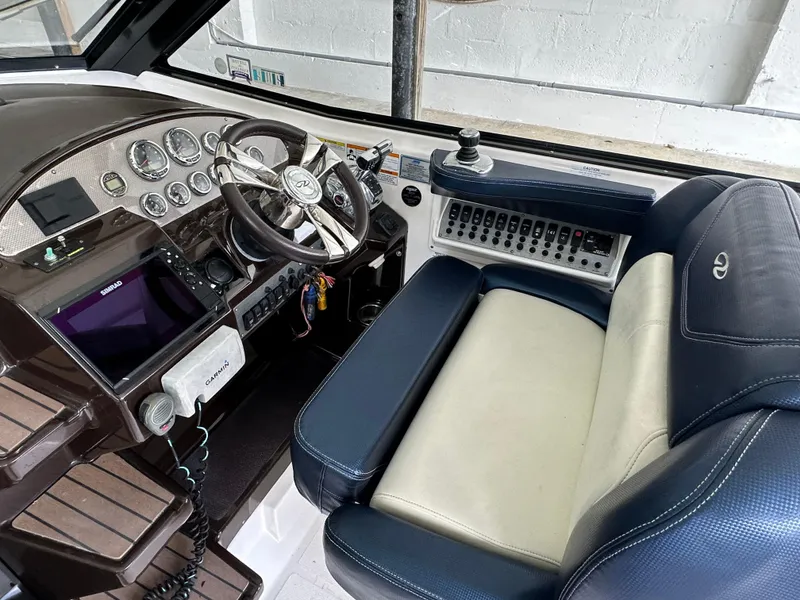 Slide: The Image of 2014 Regal 35 Sport Coupe helm with steering wheel, gauges, and leather seating. - 13