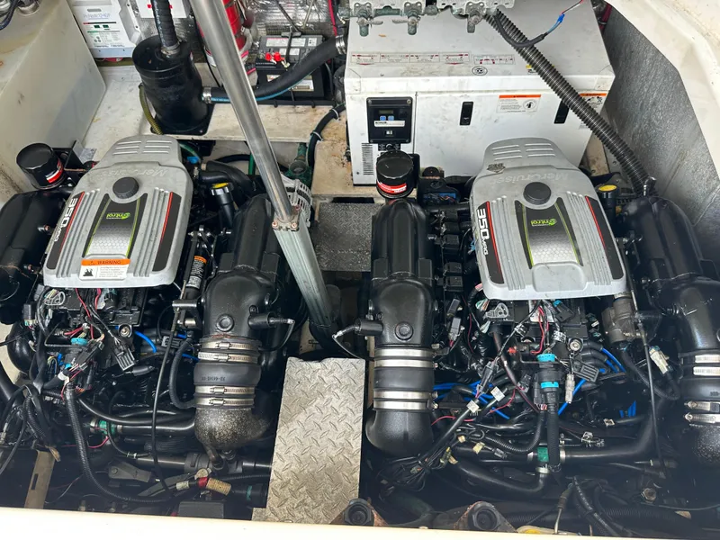 Slide: The Image of 2014 Regal 35 Sport Coupe engine compartment with dual inboard motors and mechanical components. - 19