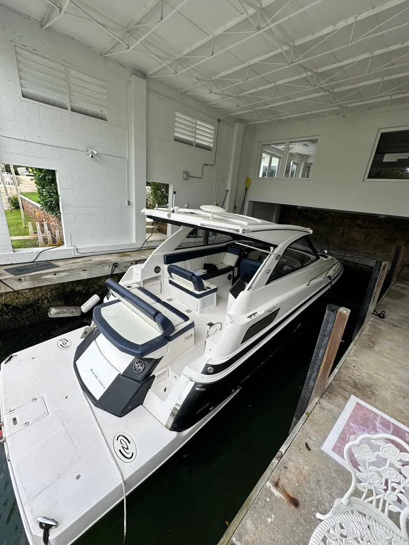 Slide: The Image of 2014 Regal 35 Sport Coupe in indoor dock, sleek design, white exterior. - 3
