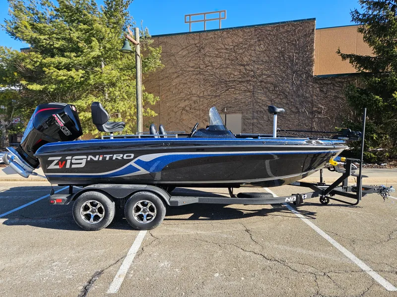 The Image of 2025 Nitro ZV19 boat on trailer in parking lot, side view. - 0