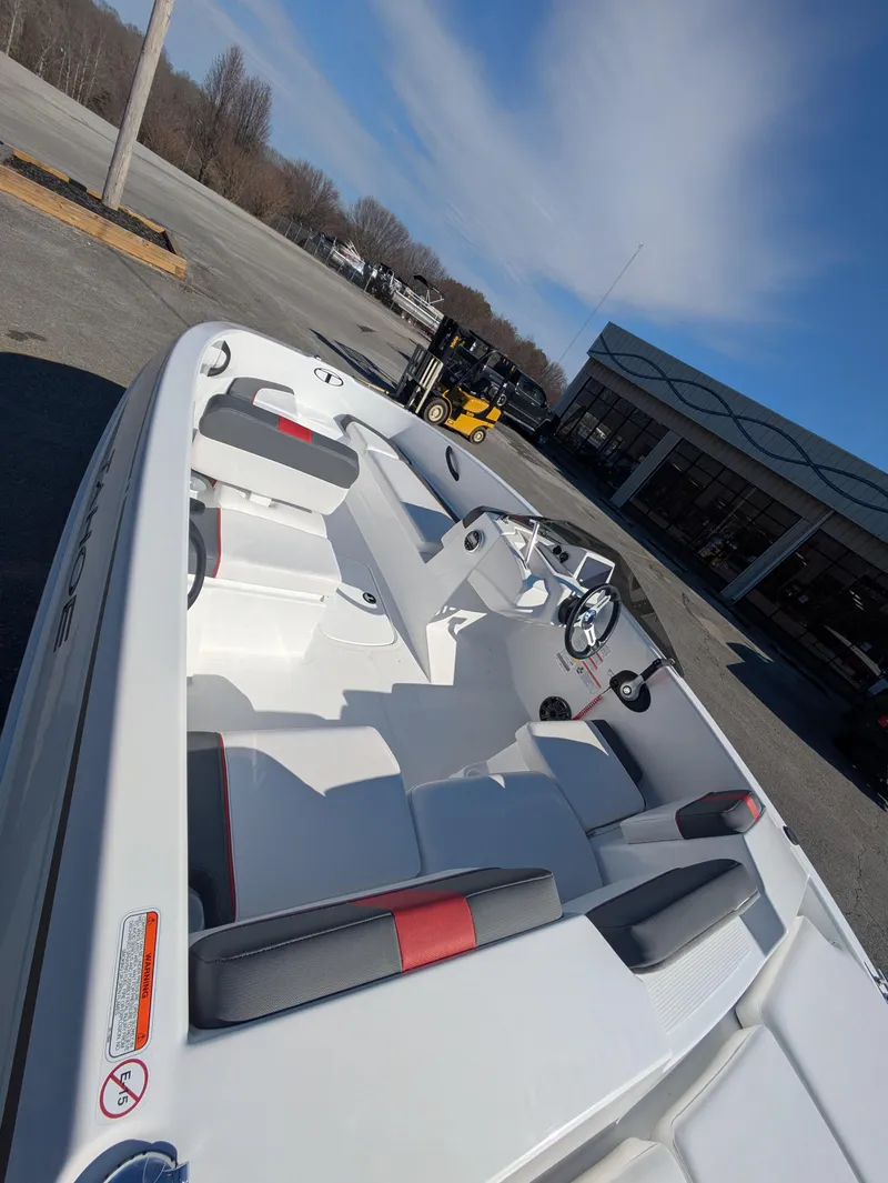 Slide: The Image of 2025 Tahoe T16 boat with sleek white interior and modern design, parked outdoors. - 5